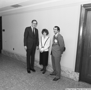 ["Senator John D. (Jay) Rockefeller stands in a hallway with a student and teacher from West Virginia. The student was chosen by the governor as an outstanding high school science student as part of the National Institute of Health Centennial Year celebration."]%