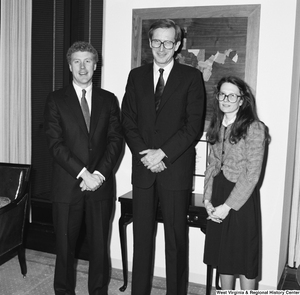 ["Senator John D. (Jay) Rockefeller stands in his office between an unidentified man and woman."]%