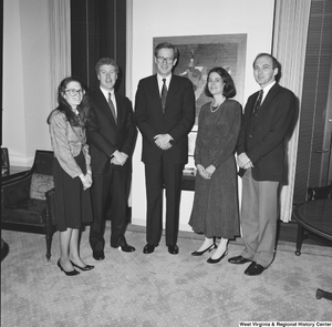 ["Senator John D. (Jay) Rockefeller stands with four unidentified individuals in his office."]%