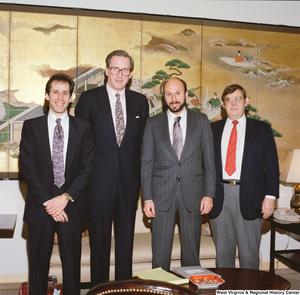 ["Senator John D. (Jay) Rockefeller stands next to three unidentified men in his office."]%