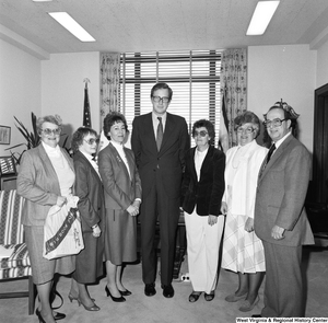 ["Senator John D. (Jay) Rockefeller stands among representatives from the West Virginia Alliance of Mentally Ill in his office."]%
