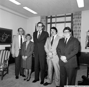 ["Senator John D. (Jay) Rockefeller greets four unidentified individuals in his office and poses for a photograph with them."]%