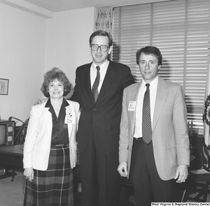 ["Senator John D. (Jay) Rockefeller stands in his office between two representatives from the West Virginia Family Resource Network."]%
