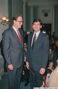 ["Senator John D. (Jay) Rockefeller stands next to a man before an event in the Senate begins."]%