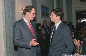 ["Senator John D. (Jay) Rockefeller speaks to a man before an event in the Senate."]%