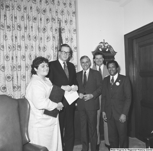 ["After a meeting with Senator John D. (Jay) Rockefeller, a group of officials from Huntington, WV poses for a photograph in his office."]%