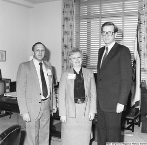 ["Senator John D. (Jay) Rockefeller stands with two representatives from the National Head Injury Foundation in his Washington office."]%