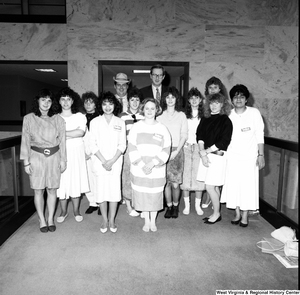 ["Senator John D. (Jay) Rockefeller stands with a group of Close Up students in the Hart Office Building."]%