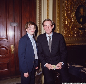 ["Senator John D. (Jay) Rockefeller sits next to an unidentified boy and poses for a photograph in the U.S. Capitol Building."]%
