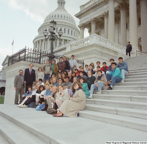 ["Senator John D. (Jay) Rockefeller stands beside a group of students on the steps of the Senate."]%