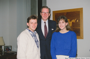["Senator John D. (Jay) Rockefeller stands with two students in his office."]%