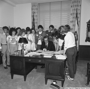 ["Senator John D. (Jay) Rockefeller points to a map while meeting with an unidentified group of students in his Washington, D.C. office."]%