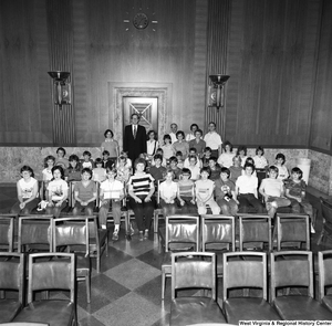 ["Senator Rockefeller stands for a photograph with a large unidentified group of young students in a Senate office building."]%