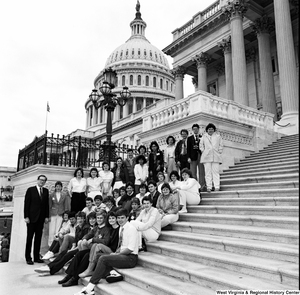 ["Senator John D. (Jay) Rockefeller stands for a photograph on the Capitol Building steps with a group of students from West Virginia's Fourth Congressional District"]%