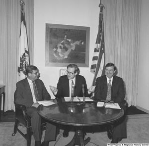 ["Senator John D. (Jay) Rockefeller sits between representatives from the National Coal Association and Consumers United for Rail Equity to announce West Virginia coal savings."]%