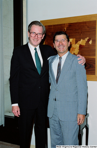 ["Senator John D. (Jay) Rockefeller poses for a photograph with an unidentified man in his office."]%