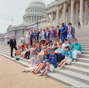 ["Senator John D. (Jay) Rockefeller stands with a group of school children on the steps of the Senate at the U.S. Capitol Building."]%
