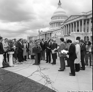 ["This wide angle photograph shows an alternative motor fuels press event outside the Senate building."]%