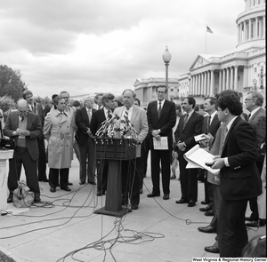 ["Senator John D. (Jay) Rockefeller stands behind a man at an alternative motor fuels event outside the Senate."]%