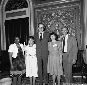 ["Senator John D. (Jay) Rockefeller stands for a photograph with unidentified members of Save the Children at the U.S. Capitol."]%