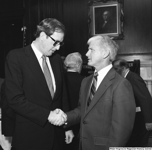 ["Senator John D. (Jay) Rockefeller shakes hands with WVU President Neil S. Bucklew at a WVU Alumni Association event in Washington."]%