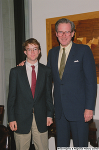 ["Senator John D. (Jay) Rockefeller stands with one of his interns."]%