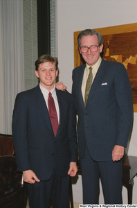 ["Senator John D. (Jay) Rockefeller stands beside one of his student interns."]%