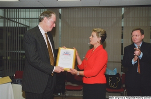 ["Senator John D. (Jay) Rockefeller accepts an award from the Federation of American Women's Clubs Overseas. The award reads \"FAWCO Circle of Honor: Presented to Senator John D. Rockefeller IV in Grateful Recognition of His Consistent Efforts on Behalf of All Overseas Americans.\""]%