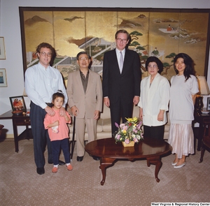 ["This color photograph shows Senator John D. (Jay) Rockefeller standing with a family in his office."]%