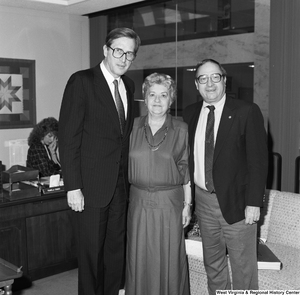 ["Senator John D. (Jay) Rockefeller stands with two unidentified individuals in his office."]%