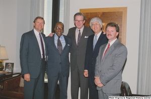 ["Senator John D. (Jay) Rockefeller stands between four men in his office."]%