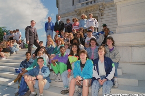 ["Senator John D. (Jay) Rockefeller stands on the steps of the Senate with students from West Virginia."]%