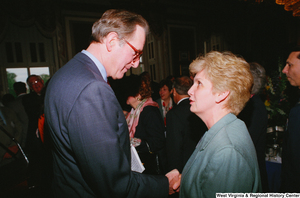 ["Senator John D. (Jay) Rockefeller shakes hands with a woman at the Celebrating Telemedicine conference."]%