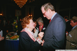 ["An unidentified woman speaks with Senator John D. (Jay) Rockefeller at a Celebrating Telemedicine event."]%