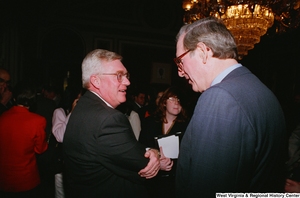 ["Senator John D. (Jay) Rockefeller speaks with an unidentified man at the Celebrating Telemedicine event in Washington."]%