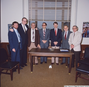["Senator John D. (Jay) Rockefeller poses for a photograph with representatives from Weirton Steel in his Senate office."]%