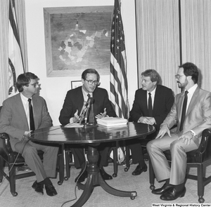 ["Senator John D. (Jay) Rockefeller sits at a round table in his office with three representatives from the steel industry."]%