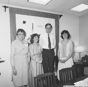 ["Senator John D. (Jay) Rockefeller stands with three unidentified women in his office."]%