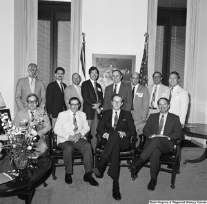 ["Senator John D. (Jay) Rockefeller poses for a photograph with a group of representatives from the Contractor's Association of West Virginia."]%