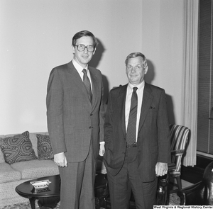 ["Senator John D. (Jay) Rockefeller stands with an unidentified man in his office."]%