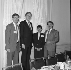 ["Senator John D. (Jay) Rockefeller stands with three representatives from the Charleston (WV) Convention Bureau during a luncheon."]%