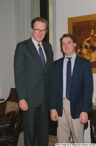 ["Senator John D. (Jay) Rockefeller stands beside an unidentified man in his office."]%