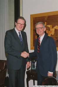 ["Senator John D. (Jay) Rockefeller shakes hands with a man in his office."]%