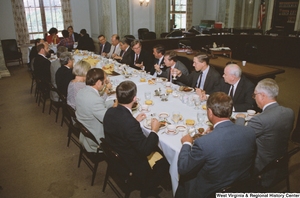 ["Senator John D. (Jay) Rockefeller attends a reception for American Electric Power in a Senate hearing room."]%