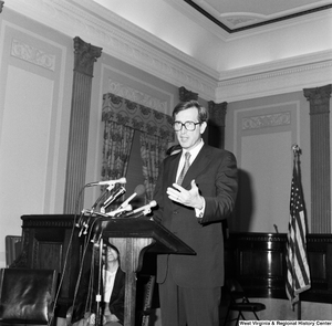 ["Senator John D. (Jay) Rockefeller speaks behind a podium."]%