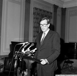 ["Senator John D. (Jay) Rockefeller stands behind a podium and speaks in one of the Senate buildings."]%