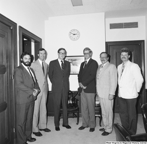 ["Senator John D. (Jay) Rockefeller stands in his office with a group of unidentified men."]%