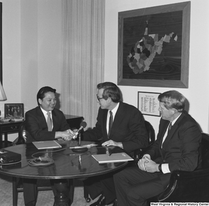 ["Senator John D. (Jay) Rockefeller shakes hands with a man during a meeting with representatives from the US Steel Mining Company."]%