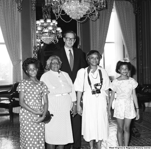 ["Senator John D. (Jay) Rockefeller stands with an unidentified family in one of the Senate buildings in Washington."]%