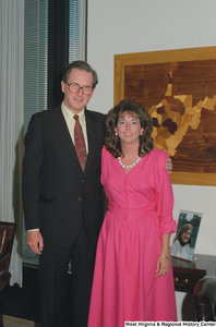 ["Senator John D. (Jay) Rockefeller stands next to an unidentified woman in his office."]%